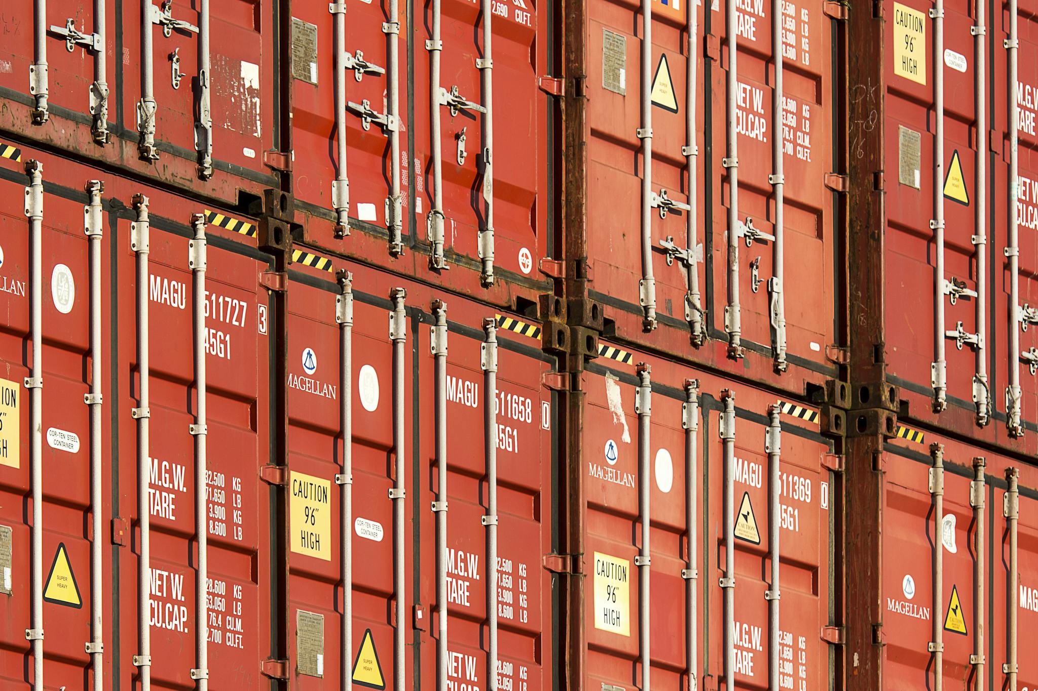 Close-up of stacked red shipping containers used for logistics and global trade.